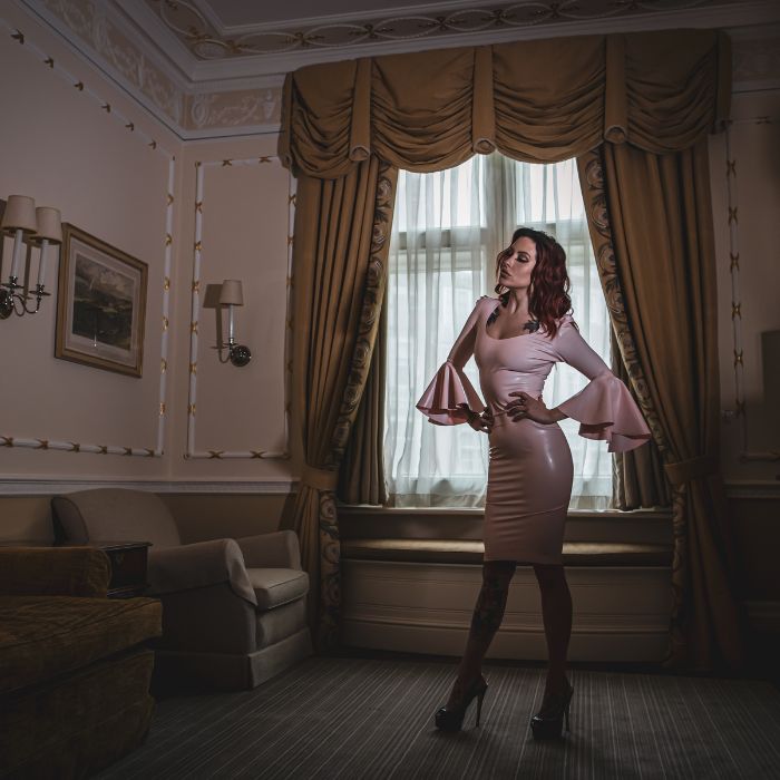 Mistress Adreena in a luxurious room.